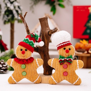 Charming knitted gingerbread man plush dolls on rustic wood base for Christmas tree decor