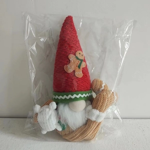 Detail of a Christmas gnome with a red knit hat featuring a gingerbread man applique