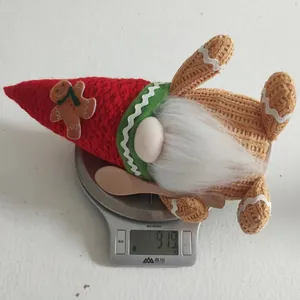 Detail shot of a Christmas gnome weight check showing 91.9g on a digital kitchen scale