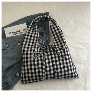 Detail shot of the black and white gingham pattern fabric with a large decorative bow tie