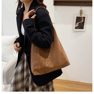 Lifestyle shot of large leopard print tote bag with soft matte texture and shoulder strap