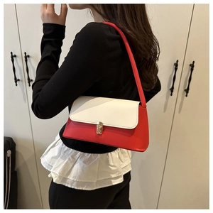 Detail of red and white PU leather handbag with a gold metal clasp shown on a model
