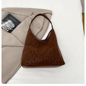 Detailed view of dark brown leopard print hobo bag with sleek shoulder strap design
