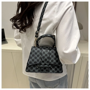 Detailed view of the black and gray M-letter monogram texture on a luxury crossbody bag