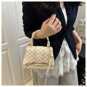 Detail of light beige monogram crossbody bag with M print and golden hardware
