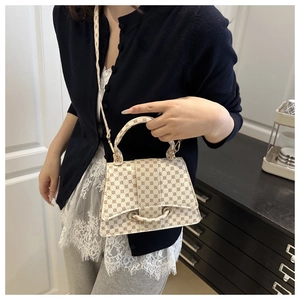 Detailed view of women's crossbody bag with vintage geometric prints and top handle