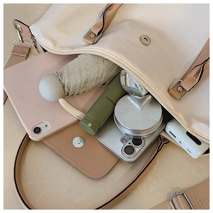 Internal view of large beige tote bag showing storage for tablet, umbrella and cosmetics