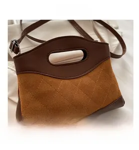 Detail of vintage brown shoulder bag showing patchwork leather and diamond quilt pattern