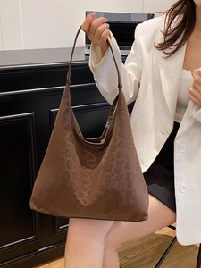 Brown leopard print oversized canvas tote bag shown with an elegant office outfit