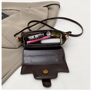 Sac bandoulière marron foncé montrant l'espace pour téléphone et accessoires divers