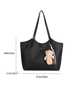 Black leather tote bag with gold lettering and plush bear charm, 39x13x25cm dimensions