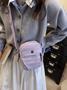 Minimalist light purple crossbody bag with adjustable wide strap and nylon texture