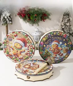 Detail of hand-painted Christmas drums featuring gingerbread man and winter snow scene