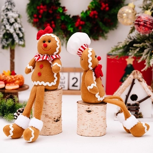 Close-up of plush gingerbread man dolls with chef hat and festive Christmas decorations