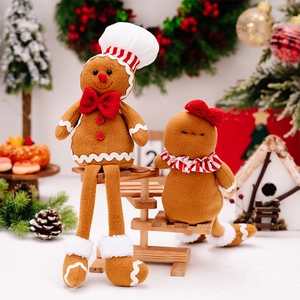 Detailed close-up of plush gingerbread man figurines with chef hat and festive bow decoration