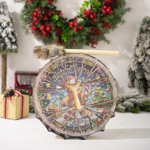Detail of Christmas gingerbread man drum with plush mallet and festive holiday ornaments