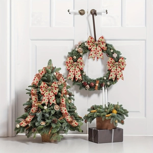 Close-up of Christmas wreath and mini tree with polka dot ribbons and pine cones