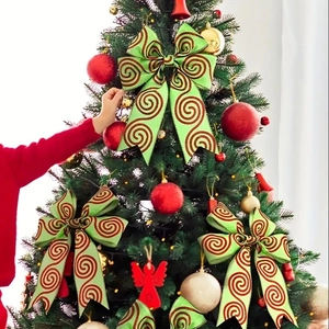 Close-up of a light green glitter bow decoration on a Christmas tree with festive ornaments