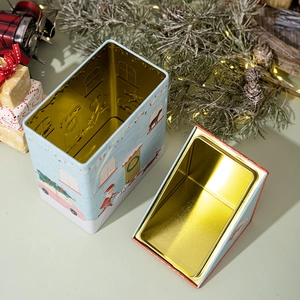 Detailed view of the golden interior and festive blue Christmas dog house tin box