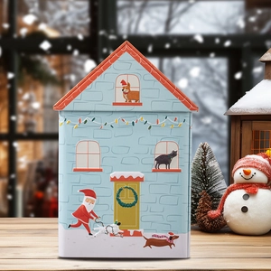 Detailed view of dog house shaped Christmas tin with festive illustrations on a wood surface