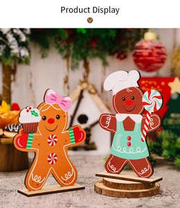 Detailed close-up of colorful gingerbread man and woman wooden Christmas tabletop ornaments