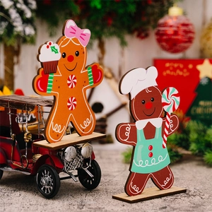 Detail of two Christmas gingerbread man wooden desk ornaments with colorful festive paint