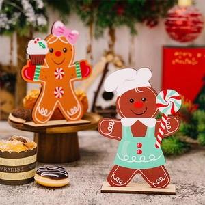 Detailed view of two gingerbread man wooden table ornaments with festive Christmas decor