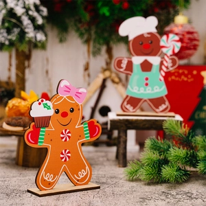 Close-up of wooden gingerbread man and chef figurines with cupcakes and candy canes