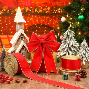 Red velvet Christmas ribbon with gold edges and festive bow in a warm holiday setting