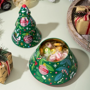 Detail of Christmas tree tin box filled with candies on a festive holiday background