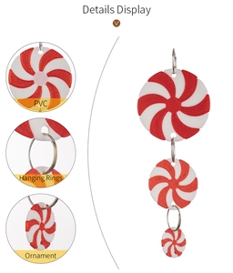 Detailed view of red and white PVC peppermint candy ornament with durable metal hanging rings