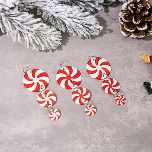 Close-up of red and white peppermint candy hanging ornaments for Christmas tree decor