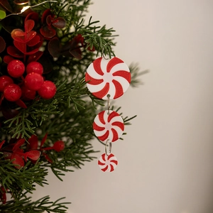 Close-up of red and white peppermint candy hanging ornaments on a festive Christmas tree