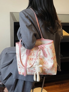 Cute white tote bag with pink trim, cartoon bear prints and a plush rabbit charm