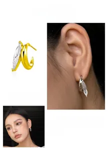 Detail of C-shaped stud earrings with marquise-cut crystal in gold and silver finish
