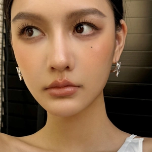 Minimalist silver marquise C-shape stud earrings on model with high-end abstract twist