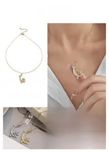 Detailed view of star and crescent moon pendant necklace with crystal embellishments