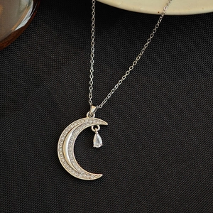 Silver crescent moon necklace with micro-p镶te crystals and a hanging water drop pendant