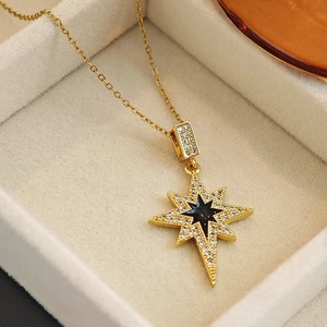 Elegant gold eight-pointed star necklace with black center and sparkling zircon inlay