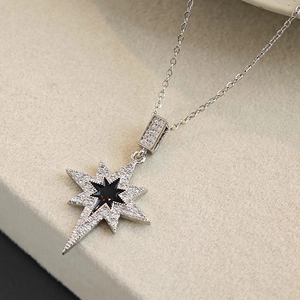 Elegant silver eight-point star pendant necklace with white zircons and black enamel center