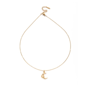Detail of adjustable gold necklace with moon and sun pendant with blue zircon stones
