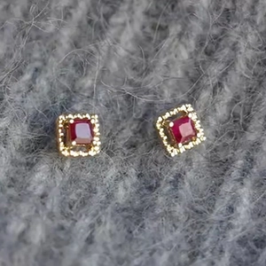 Minimalist square red zircon stud earrings with gold plating on grey plush fabric