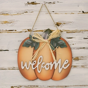 Close-up of wooden pumpkin welcome sign with 3D lettering and rustic burlap bow