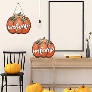Close-up of harvest orange pumpkin welcome sign with green leaves and rustic twine