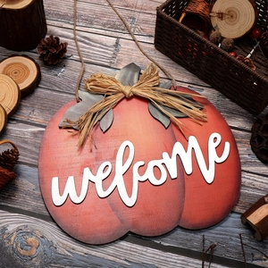 Orange wood pumpkin welcome sign with raffia bow for autumn harvest front door decor