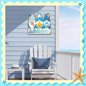 Detail of wooden welcome sign featuring beach gnomes with sea shells and starfish decor