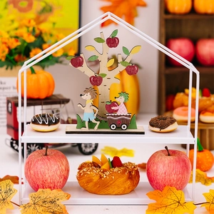 Detailed view of autumn-themed wooden hedgehog and apple tree ornaments for home decor