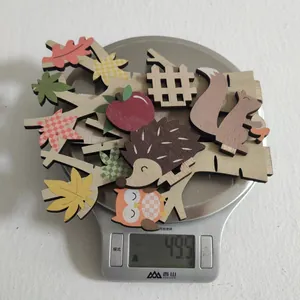 Detail showing weight of laser-cut wooden forest decorations with hedgehog and owl