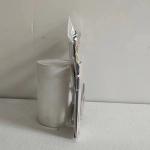 Side view of thin wooden Thanksgiving ornament in clear plastic packaging