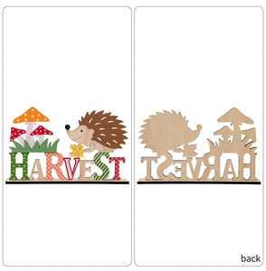 Detail of wooden harvest tabletop decor featuring hedgehog and mushrooms with harvest letters